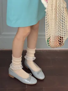 Detailed view of sweet Japanese style lace ruffle stacking socks worn with cute flats.