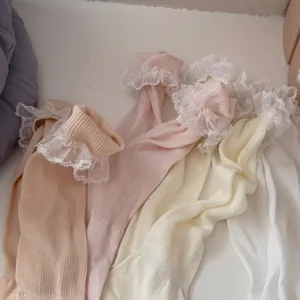 Close up of sweet Japanese style lace ruffle slouch socks in pastel colors soft breathable fabric