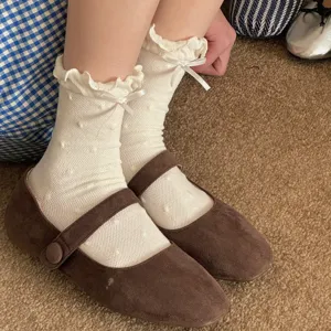 Cute white ruffled mid-calf socks with sweet bow knots and polka dots for women daily wear.