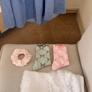 Japanese style bow grid mid-tube socks detail view with matching sweet scrunchie and lace fabric.