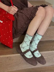 Japanese style cute rolled edge mid-tube socks with elegant bow patterns for women daily wear.