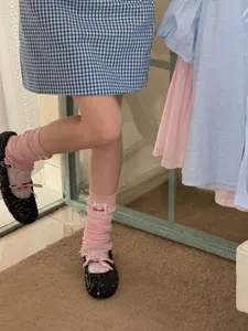 Pink knit leg warmers detail showing soft fabric texture and cute ruffles for daily wear.