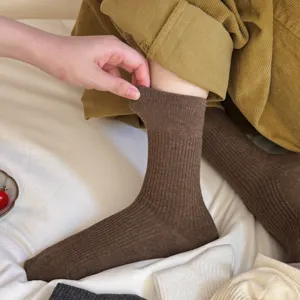 Brown ribbed knit socks detail, showing elastic cuff stretch and soft cotton texture close-up.