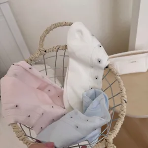 Detailed view of cute women's ankle socks in pink, white, and blue colors featuring lovely dots.