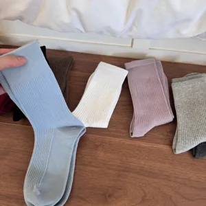 Solid color ribbed mid tube socks for women, comfortable versatile knit long socks in various colors.