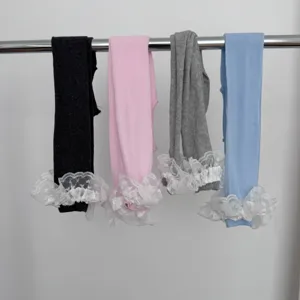 Detailed view of women casual lace ruffle leggings featuring four solid colors on rack.