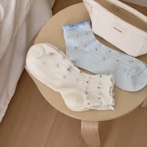 Detailed view of sweet women's thin breathable ruffle socks with cute polka dot patterns.