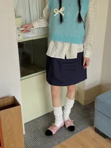 Stylish women's leg warmers white knitted slouch socks y2k aesthetic daily outfit detail shot.