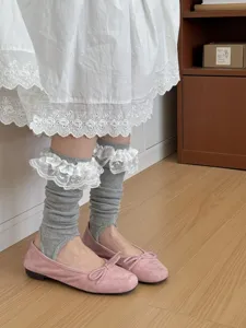 Grey stirrup socks with white lace ruffle trim, stylish casual hosiery for women and girls.