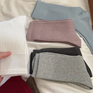 Solid color ribbed knit long socks detail showing soft texture and cozy autumn winter wear.