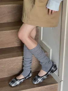 Grey ribbed stirrup leg warmers detail shot, soft knit fabric for stylish Y2K fashion outfits.