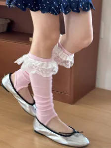 Pink ruffle trim stirrup slouch socks detail view featuring sweet design for women