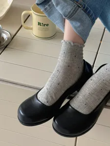 Grey polka dot ruffled ankle socks detail view, breathable thin fabric comfortable wear.