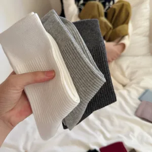 Solid color ribbed mid-tube socks for women, comfortable daily winter casual wear.