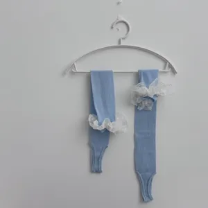 Women light blue stirrup slouch socks with elegant white lace ruffles for stylish daily wear.
