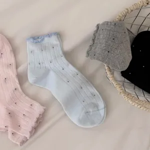 Detailed close-up of women's cute ruffled socks with delicate dots and soft breathable fabric.