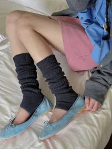 Dark grey ribbed stirrup leg warmers detail shot, soft knitted fabric for cozy daily wear.
