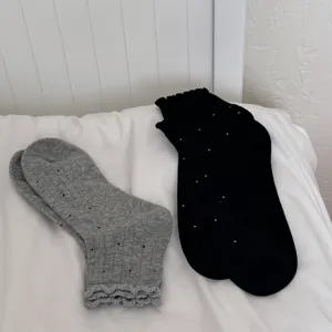 Close-up detail of women summer sheer polka dot socks featuring cute lace ruffle cuffs.