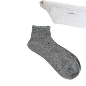 Grey women's short socks featuring sweet polka dots and a delicate ruffled lace trim design.
