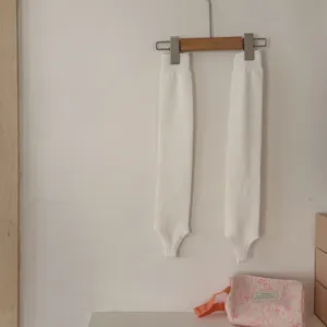Vista dettagliata di scaldamuscoli bianchi lavorati a maglia, morbidi per il look.