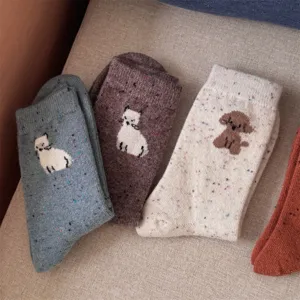 Close-up detail of cute cat and dog pattern speckled wool socks, showing soft knit texture.