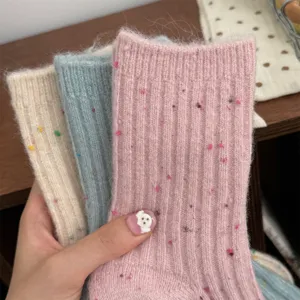 Detail shot of thick cashmere speckled mid-calf socks for women, cozy winter knitwear.