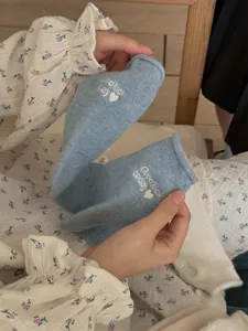 Blue wool roll-edge women socks with cute embroidery detail, soft and warm winter thermal socks.