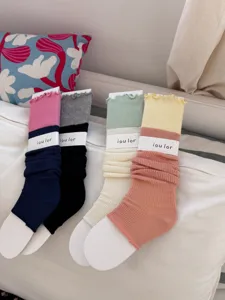 Detailed shot of Korean style color block ruffle edge stirrup leg warmers, soft and breathable.
