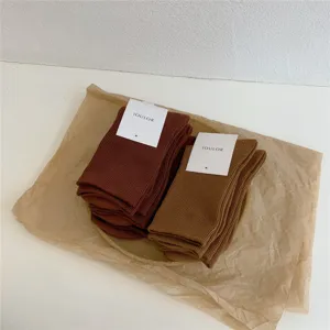 Chaussettes mi-hautes côtelées unies, tricot en coton doux pour un style quotidien.