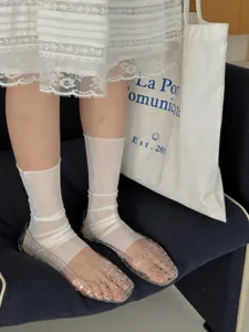 Detail view of women's white ice silk lyocell stirrup socks, breathable slouch leg covers.