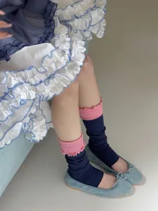 Korean style colorblock ruffled stirrup leg warmers detail shot showing cozy spring wear.