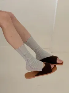 Sheer mesh leg warmers detail showing delicate purple stitching and breathable summer fabric.