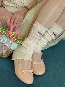 Detail shot of Japanese sweet knit leg warmers with delicate lace trim worn with flats.