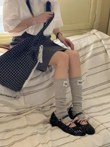 Japanese style grey knitted leg warmers for women, sweet cute ruffle socks accessory.