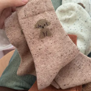 Cozy wool blend mid-calf socks featuring a cute puppy knit pattern and colorful speckles for women.