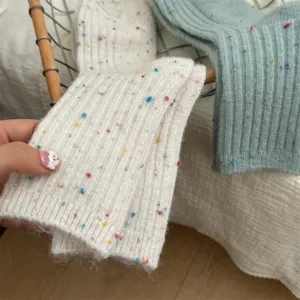 Knitted wool blend socks detail, soft textured winter crew socks with colorful flecks.