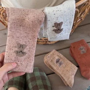 Cozy knit wool blend socks with cute dog pattern, speckled design, mid-tube, warm autumn wear.