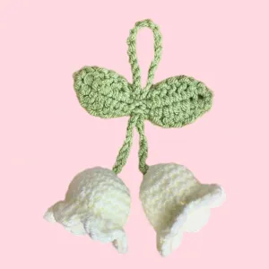 Handmade crochet lily of the valley flower pendant detail, cute wool keychain bag charm accessory.