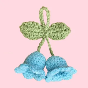 Handmade crochet lily of the valley flower pendant detail, cute blue floral wool keyring charm.