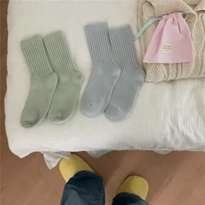Cozy ribbed knit mid-calf socks for women, warm winter daily wear, soft pastel colors set.