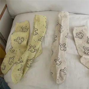 Cute cartoon puppy pattern mid-calf socks with colorful flecks, soft cotton detail view.