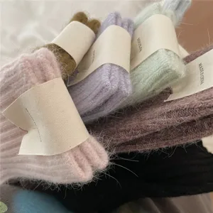 Detailed close-up of fluffy fuzzy winter warm mid-calf socks in assorted cute pastel colors.