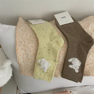 Cozy mid-tube socks with cute fluffy dog patches and colorful flecks, soft cotton material.