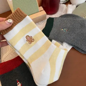 Christmas striped wool socks detail, featuring cute gingerbread man embroidery for winter wear.