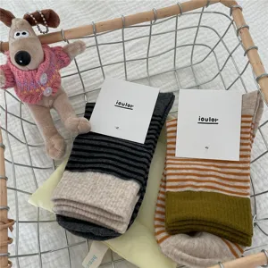 Women striped mid-calf socks with contrast cuffs, cozy knit socks for autumn wear.
