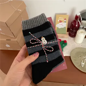 Christmas wool socks detailed view, grey black striped mid-calf socks with cute snowman embroidery.