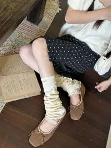 Y2K aesthetic knitted leg warmers paired with cute brown ballet flat shoes. Perfect style.