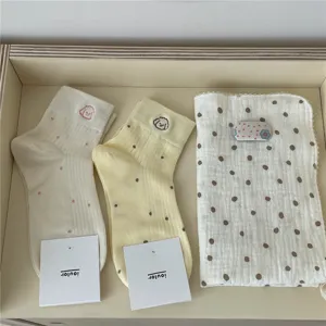 Detail view of ins-style cute dot embroidered short socks and matching soft towel set.
