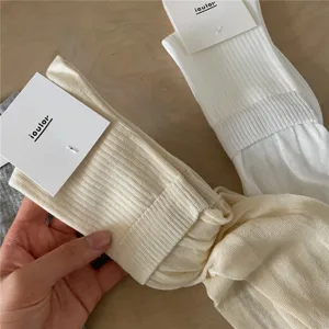 Close-up detail of soft breathable mesh slouch socks, lightweight fabric and delicate texture.