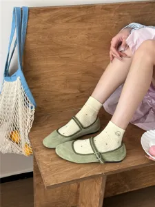 Green velvet Mary Jane flat shoes paired with cute polka dot embroidered ankle socks.